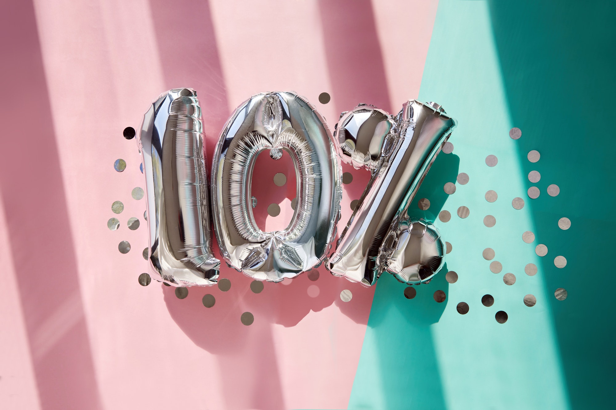 Silver numbers 10 ten percent balloons in pink turquoise background